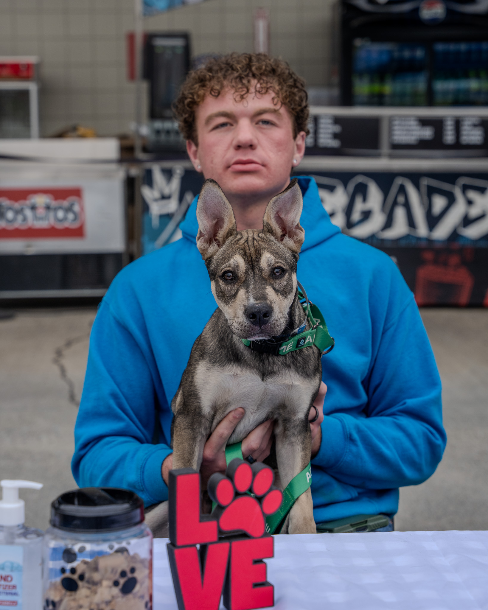 Volunteer running an HLAR outreach table at a community fair
