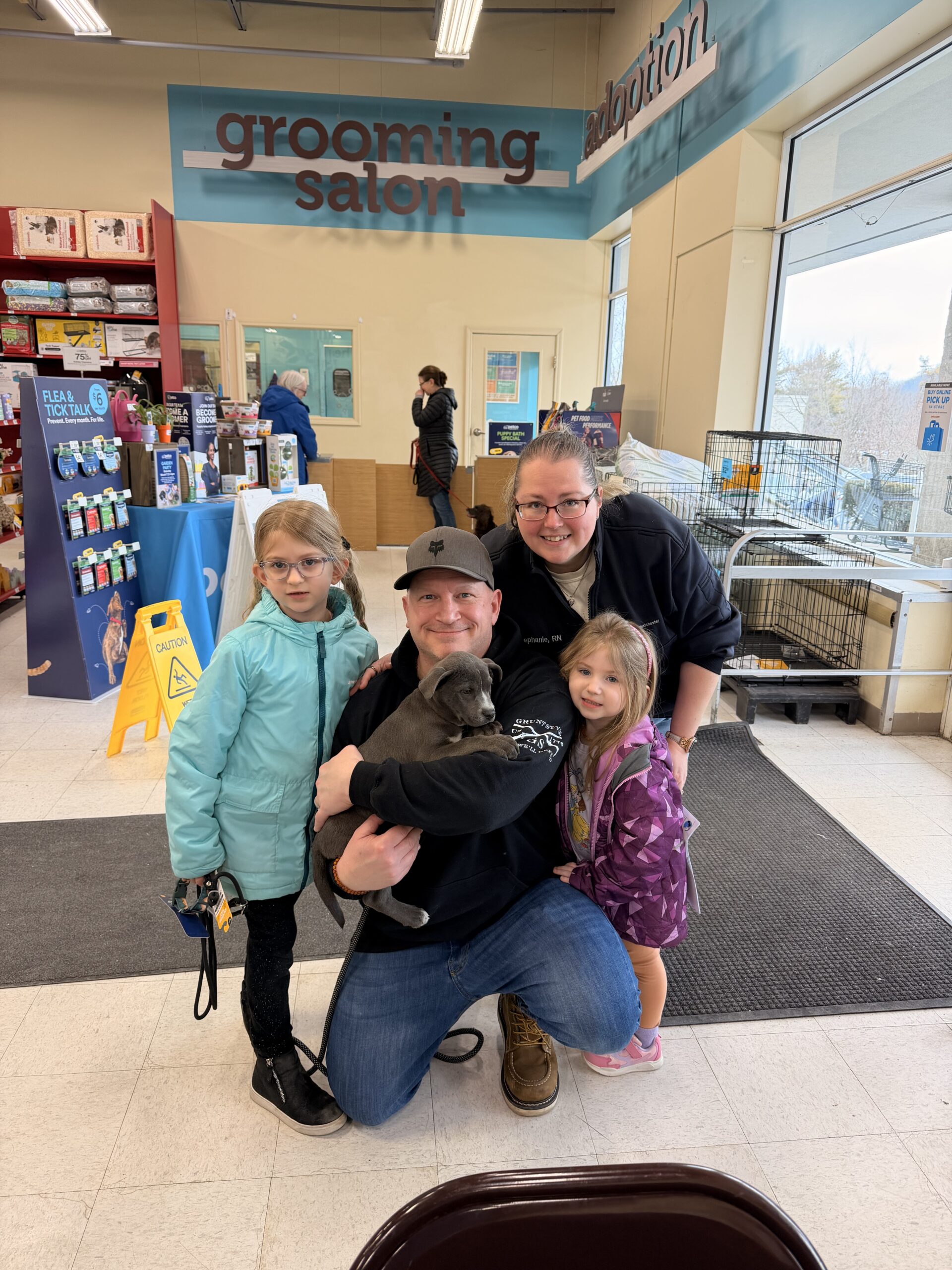 Happy family with their newly adopted dog from Happy Life Animal Rescue