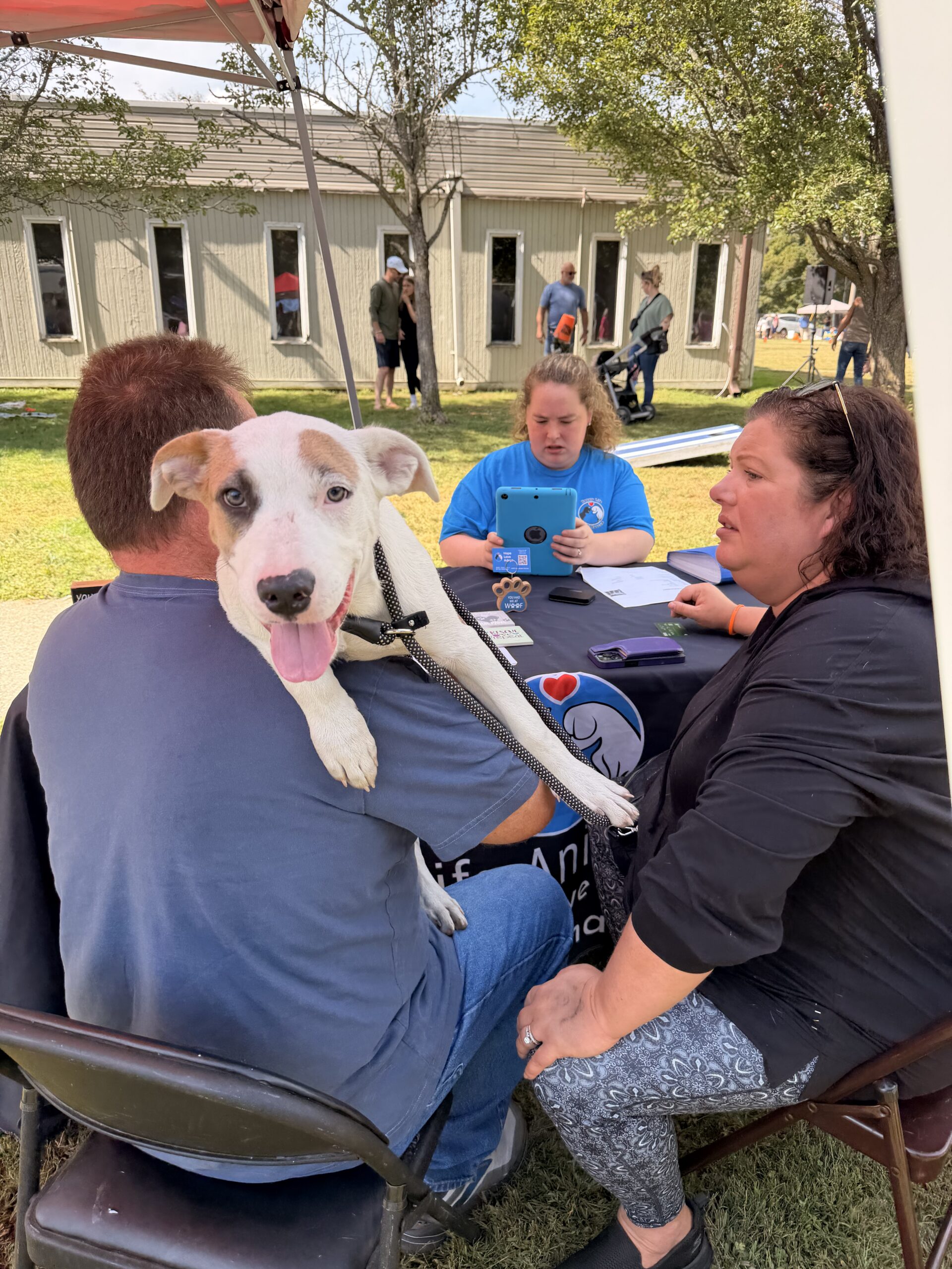 Adopters checking out with their new dog at Happy Life Animal Rescue